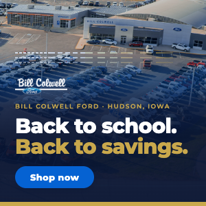 Ford dealership in Hudson, Iowa, with a back-to-school savings banner and a blue 'Shop now' button.